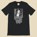 Black t-shirt with a graphic of a man in a suit and bow tie and text 'Puttin' on the Ritz'.