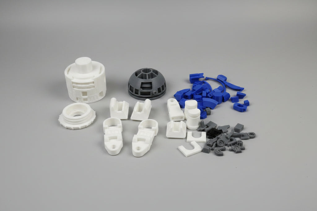 Assorted 3D printed parts on a gray background