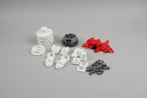 Collection of various small plastic parts on a brown surface