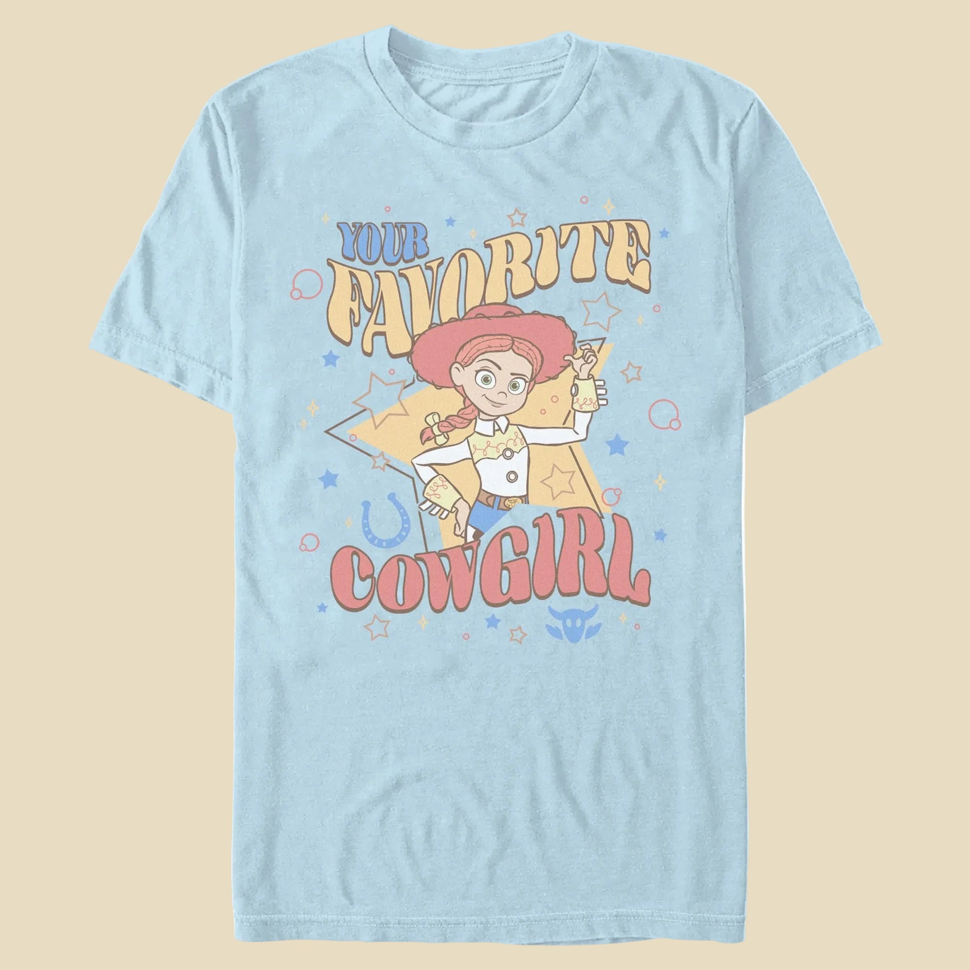A light blue t-shirt with the phrase Your Favorite Cowgirl and an animated cowgirl toy on an off-white background