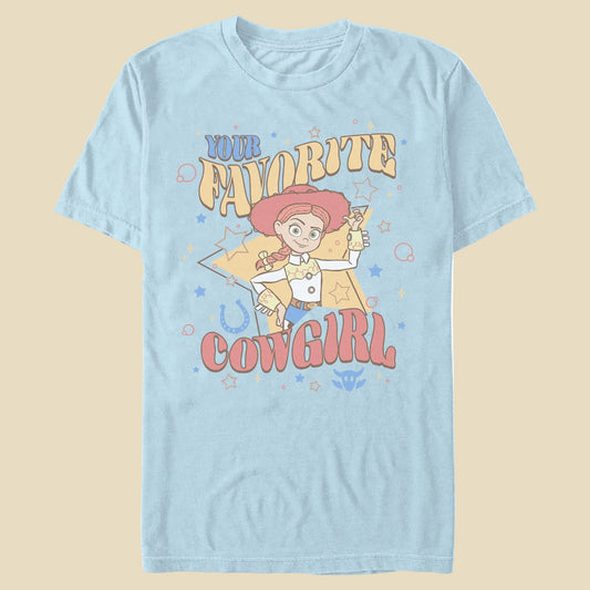 A light blue t-shirt with the phrase Your Favorite Cowgirl and an animated cowgirl toy on an off-white background