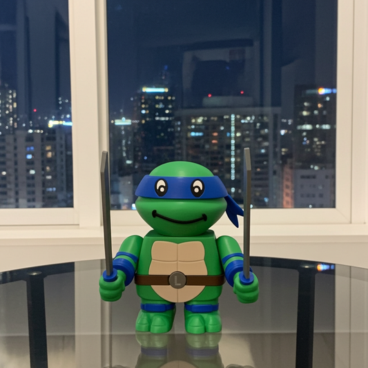 Toy turtle with blue shell holding swords in front of a window with city skyline view
